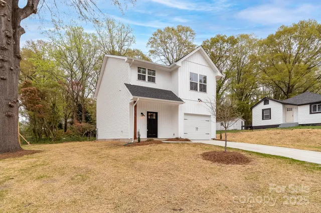 a view of a white house with a yard
