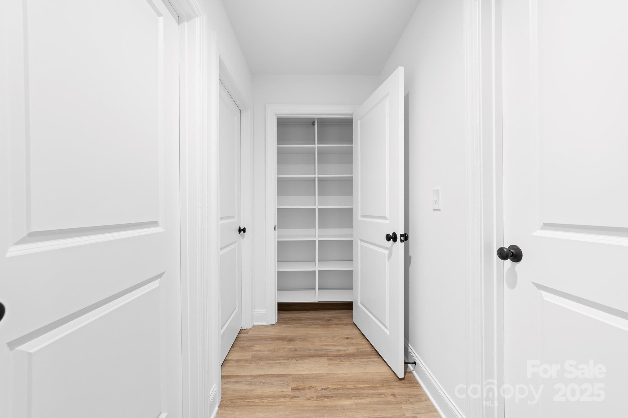 103 West Irwin Street Cherryville, NC 28021 - Photo 16 of 30 a view of a hallway with wooden floor and closet