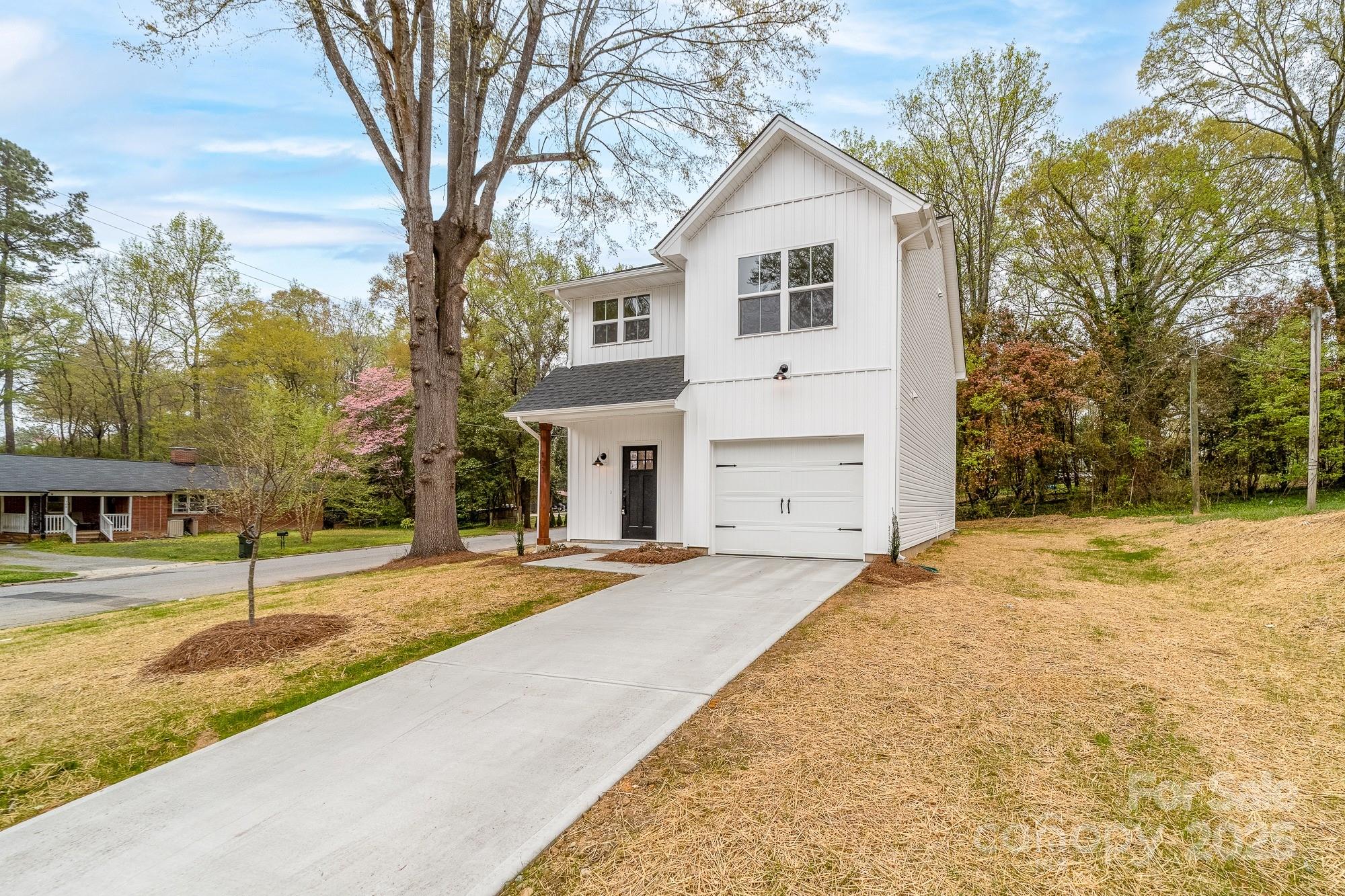 103 West Irwin Street Cherryville, NC 28021 - Photo 2 of 30 a front view of a house with a yard and garage