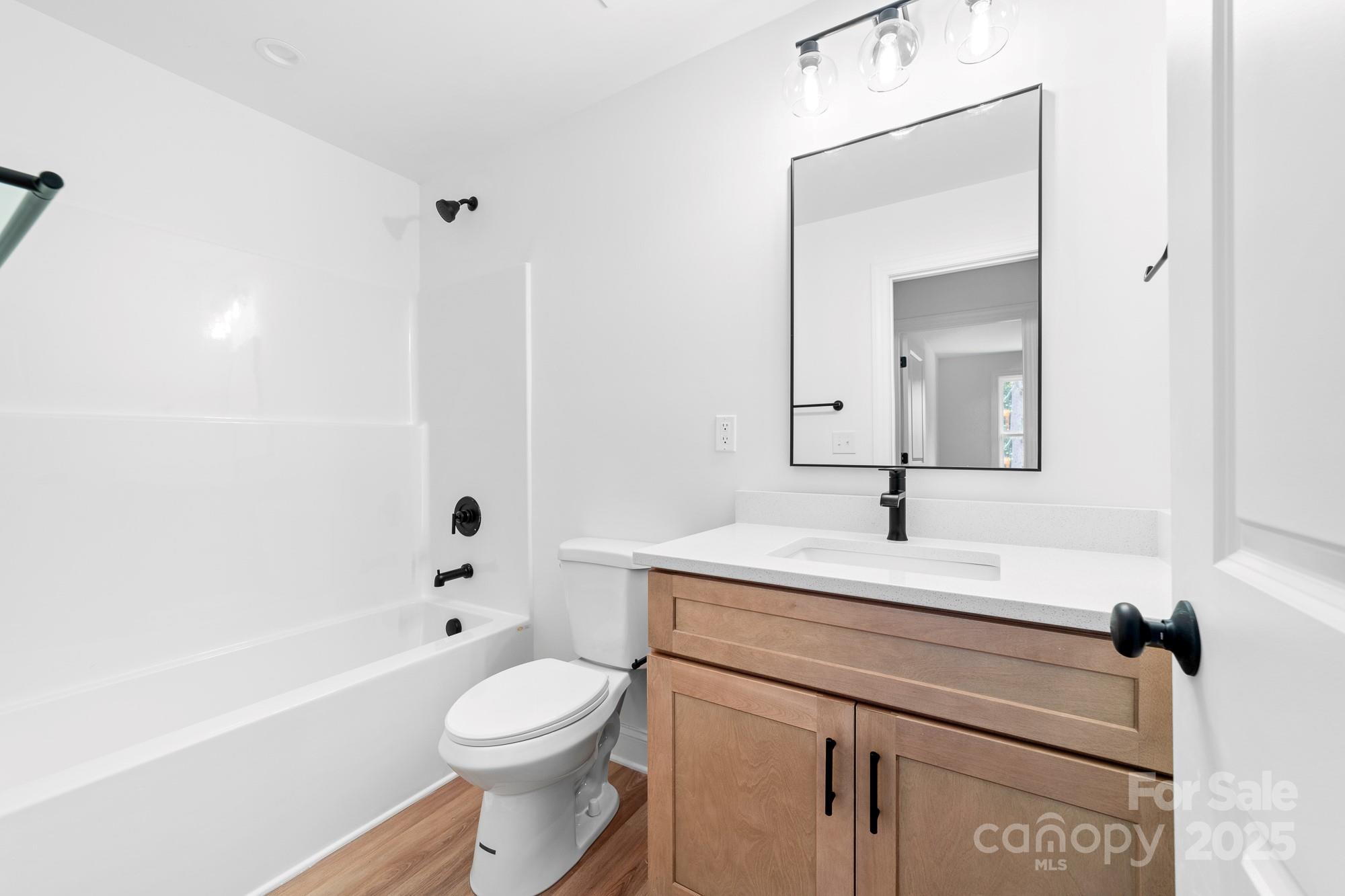 103 West Irwin Street Cherryville, NC 28021 - Photo 24 of 30 a bathroom with a sink a toilet and shower