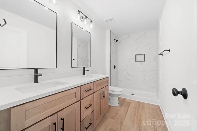 a bathroom with a sink mirror and vanity