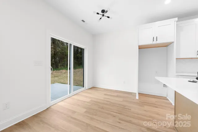 a view of a kitchen with kitchen island a sink dishwasher and a stove with wooden floor