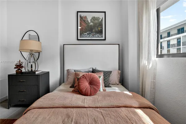 a bedroom with a bed and a painting on the wall