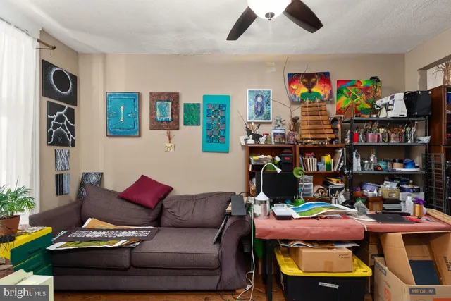 a living room with furniture and a book shelf