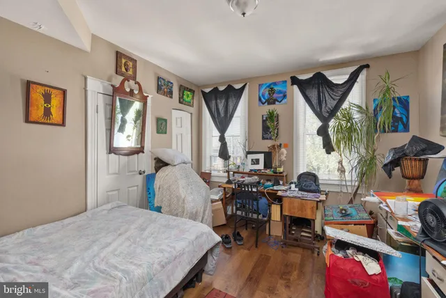 a bedroom with furniture and a wooden floor