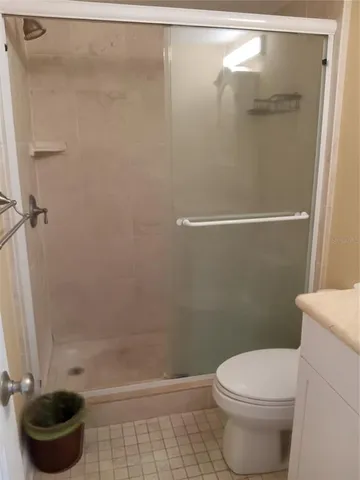 an empty room with a painting and a lamp