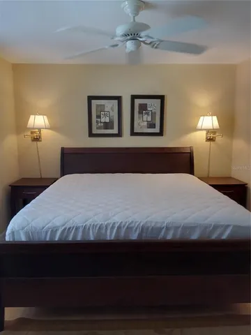 a large bedroom with a bed and a lamp