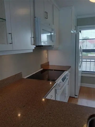 a view of a porch with furniture and wooden floor