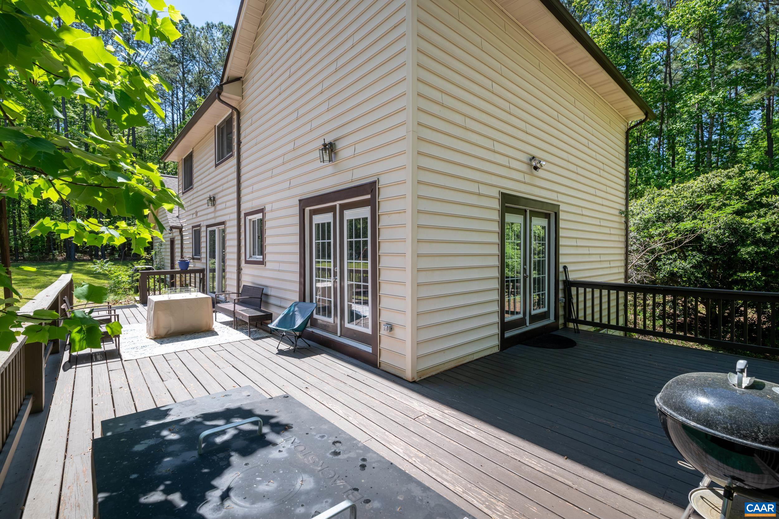 3101 Martin Kings Road Charlottesville, VA 22902 - Photo 15 of 60 a view of a patio with a table and chairs next to a house