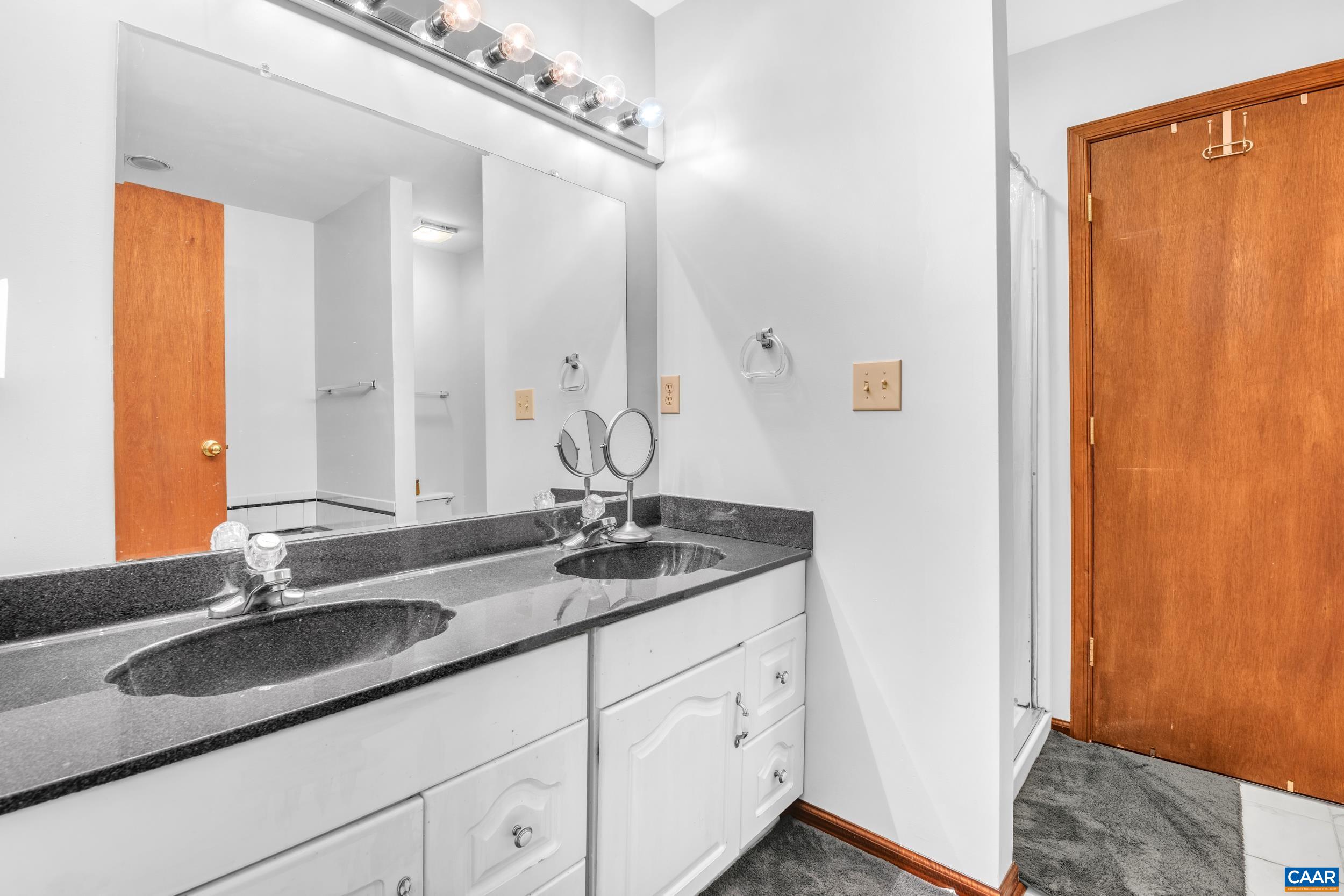 3101 Martin Kings Road Charlottesville, VA 22902 - Photo 43 of 60 a bathroom with a granite countertop sink and a mirror