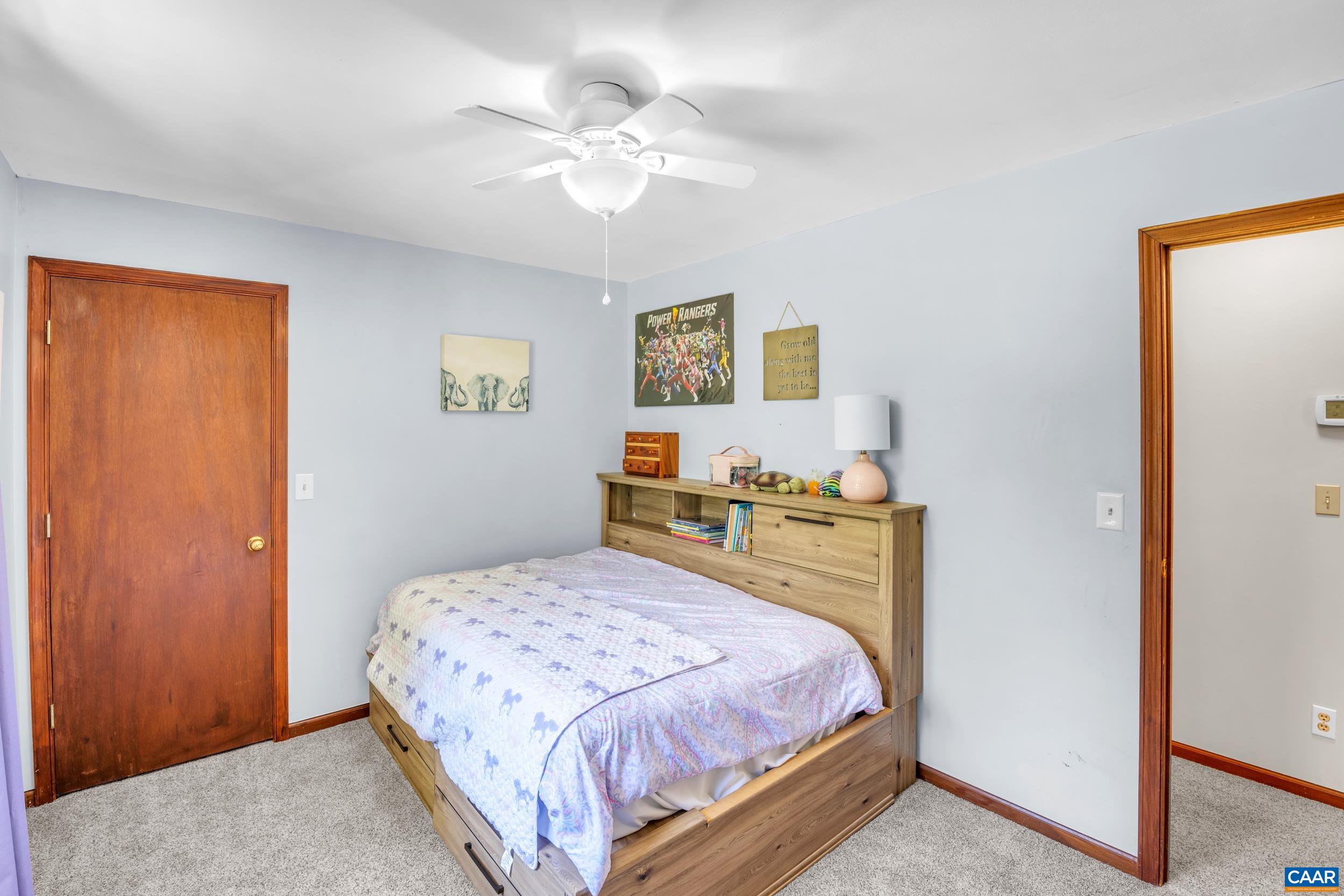 3101 Martin Kings Road Charlottesville, VA 22902 - Photo 48 of 60 a bedroom with a bed and a chandelier