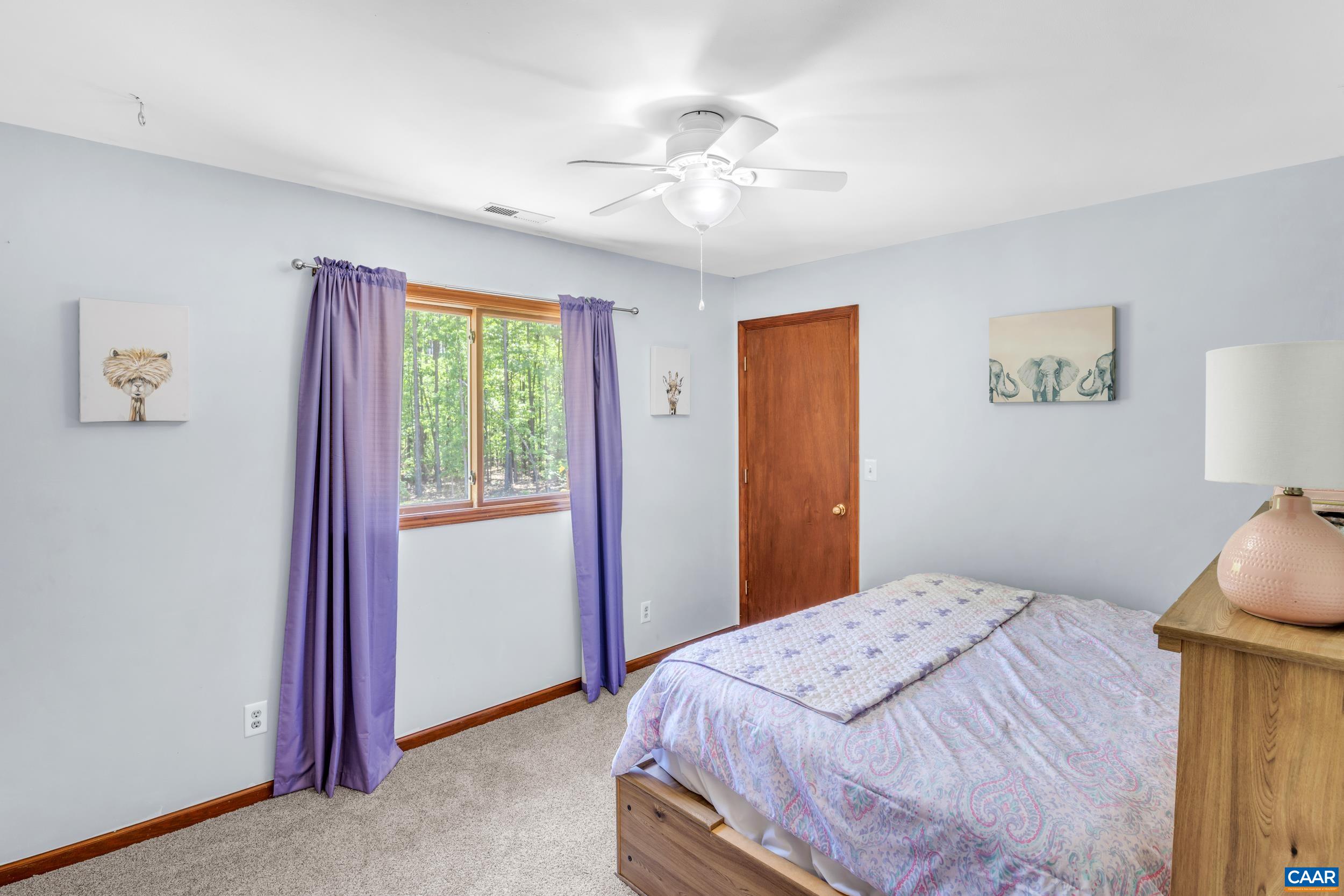3101 Martin Kings Road Charlottesville, VA 22902 - Photo 49 of 60 a bedroom with a bed and a chandelier
