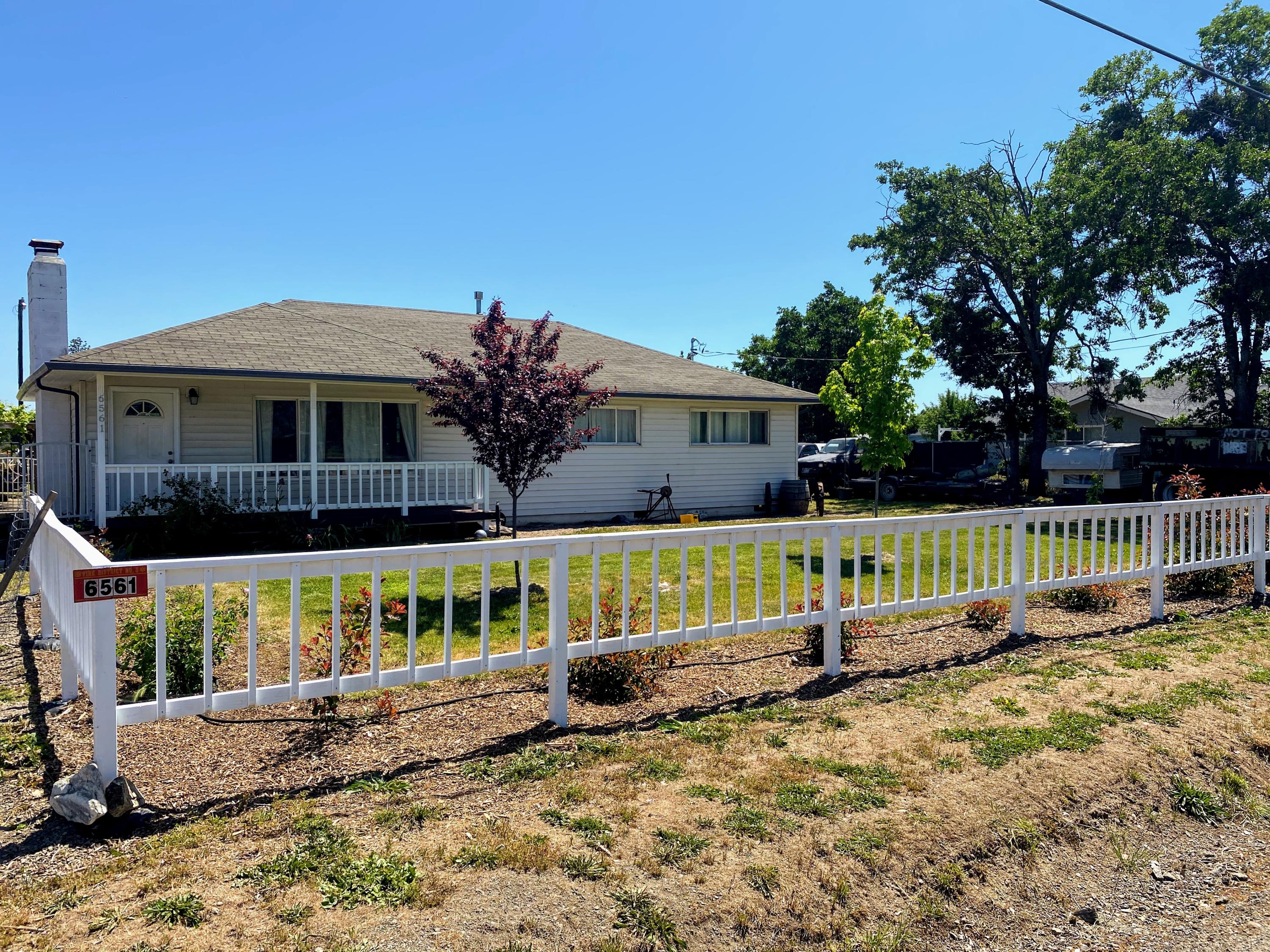 a view of house with a yard