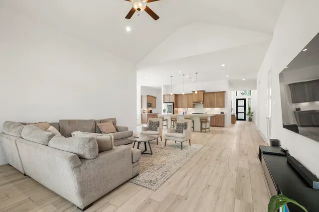 a living room with furniture wooden floor and a flat screen tv