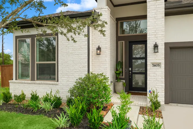 front view of a house with a potted plant