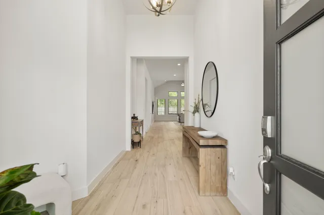 a view of a livingroom with wooden floor and a sink