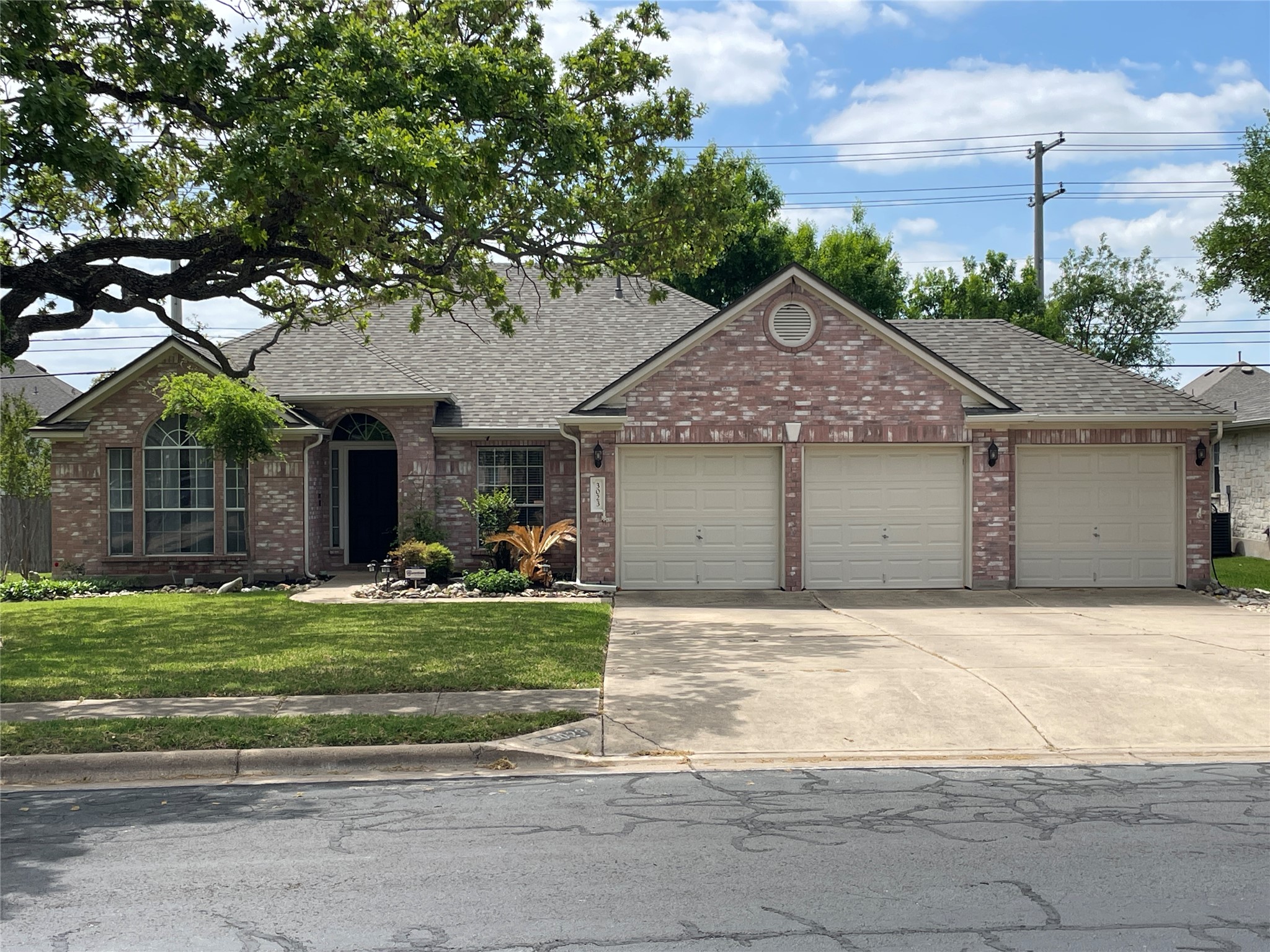 3023 Bent Tree Loop Round Rock, TX 78681 - Photo 1 of 18 Ranch-style home featuring a garage, brick siding, roof with shingles, a front lawn, and concrete driveway