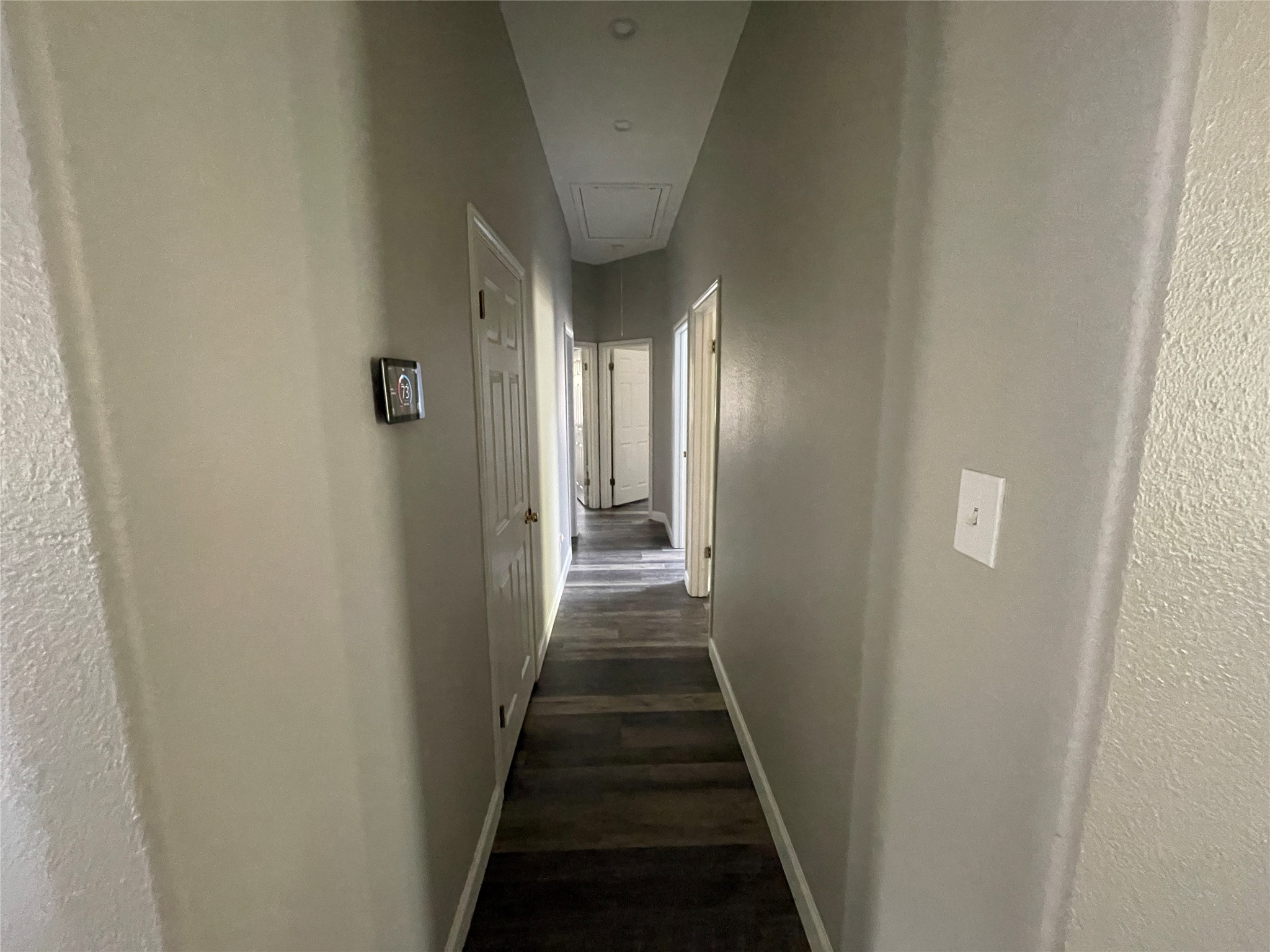 3023 Bent Tree Loop Round Rock, TX 78681 - Photo 11 of 18 Corridor with a textured wall and dark wood-type flooring