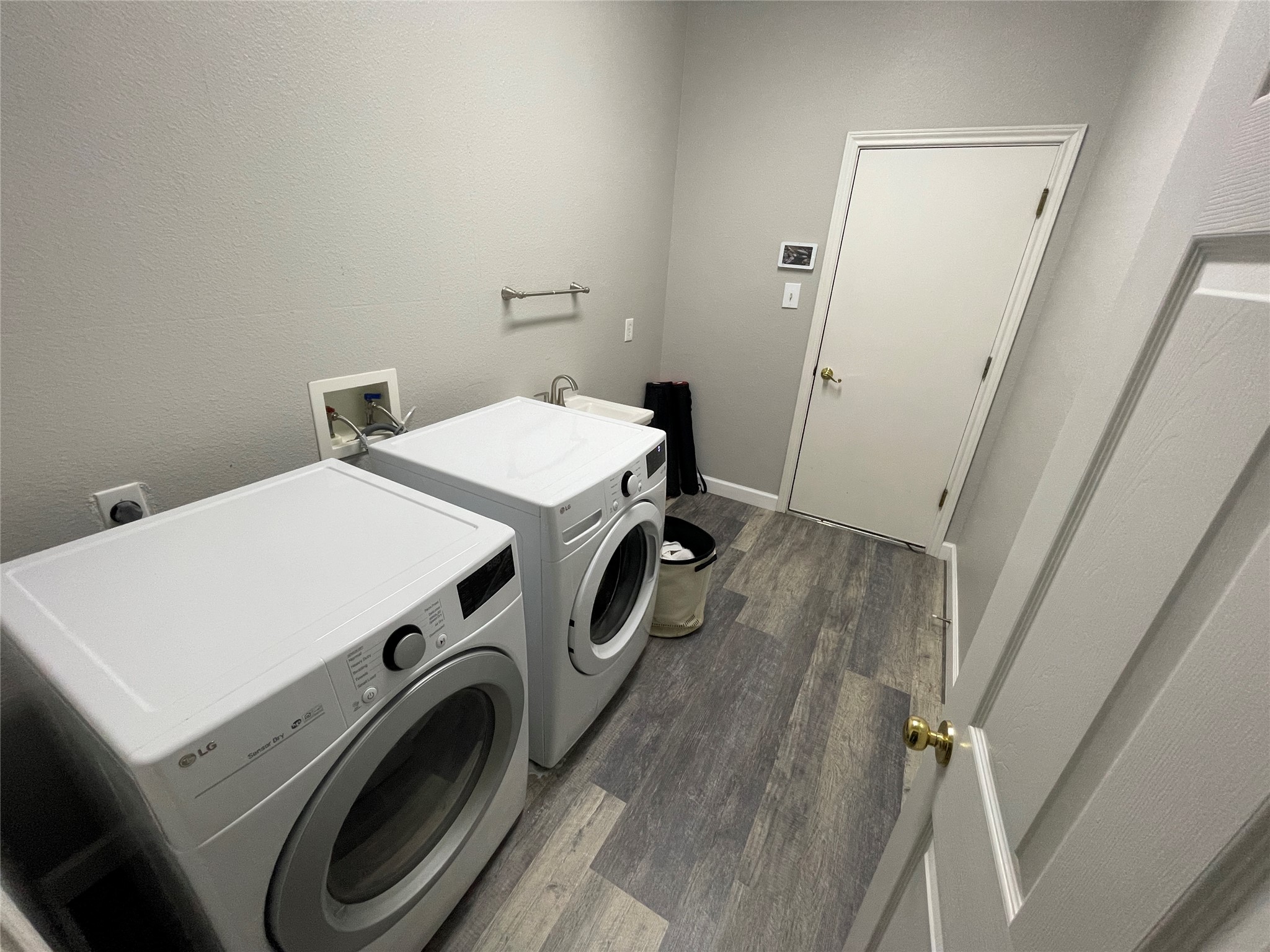 3023 Bent Tree Loop Round Rock, TX 78681 - Photo 13 of 18 Laundry room featuring dark wood-style flooring, washer and dryer, and a textured wall