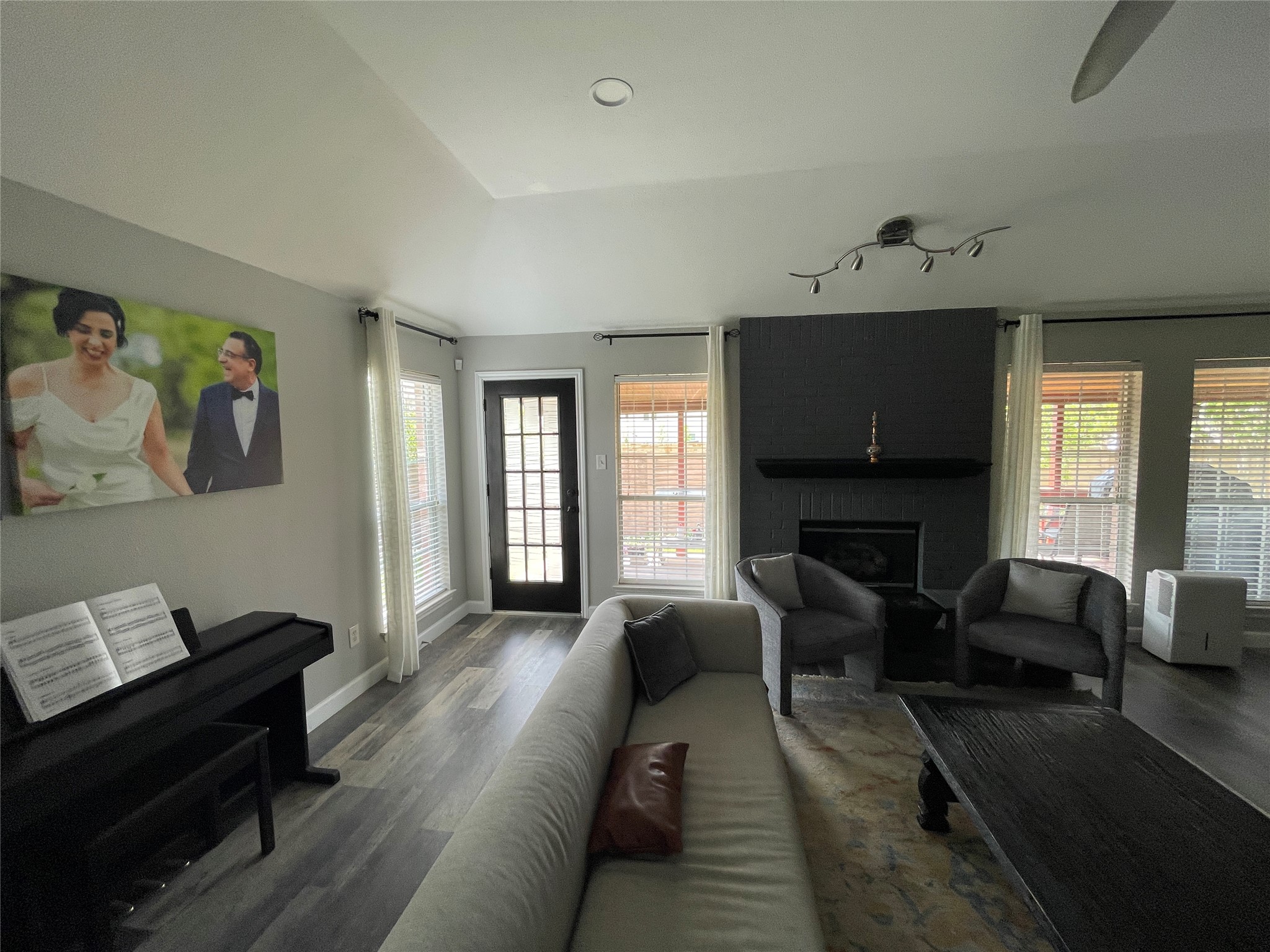 3023 Bent Tree Loop Round Rock, TX 78681 - Photo 8 of 18 Living area featuring wood finished floors, a fireplace, vaulted ceiling, and a ceiling fan