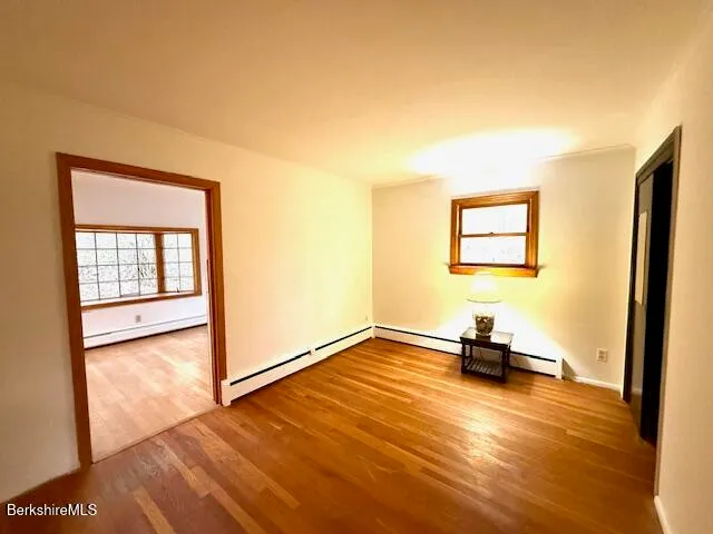 a view of a livingroom with a flat screen tv and a large window