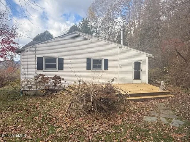 a view of a yard with wooden fence