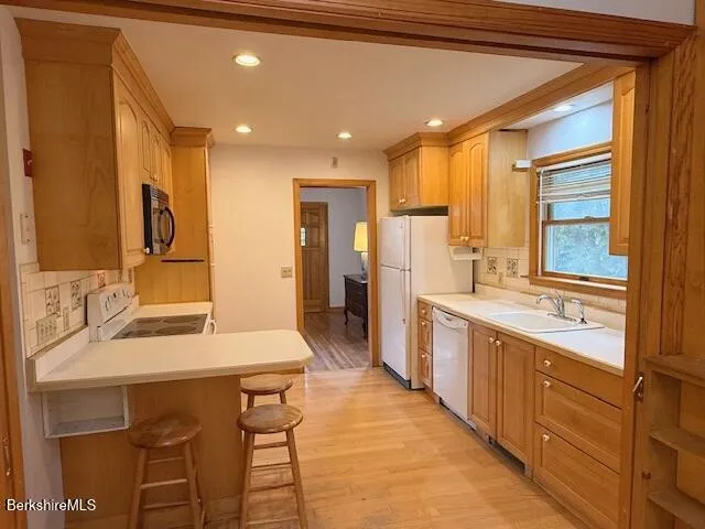 a large kitchen with a table and chairs