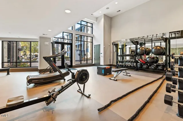 a room with gym equipment and a large window