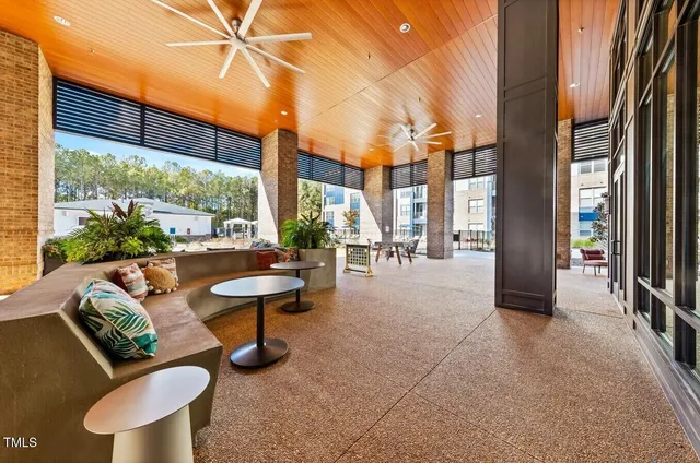 a view of a patio with couches table and chairs and potted plants