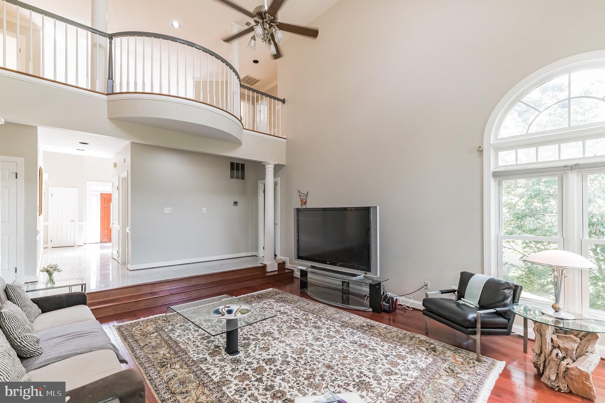 9731 Middleton Ridge Road Vienna, VA 22182 - Photo 23 of 39 a living room with furniture a rug and a flat screen tv