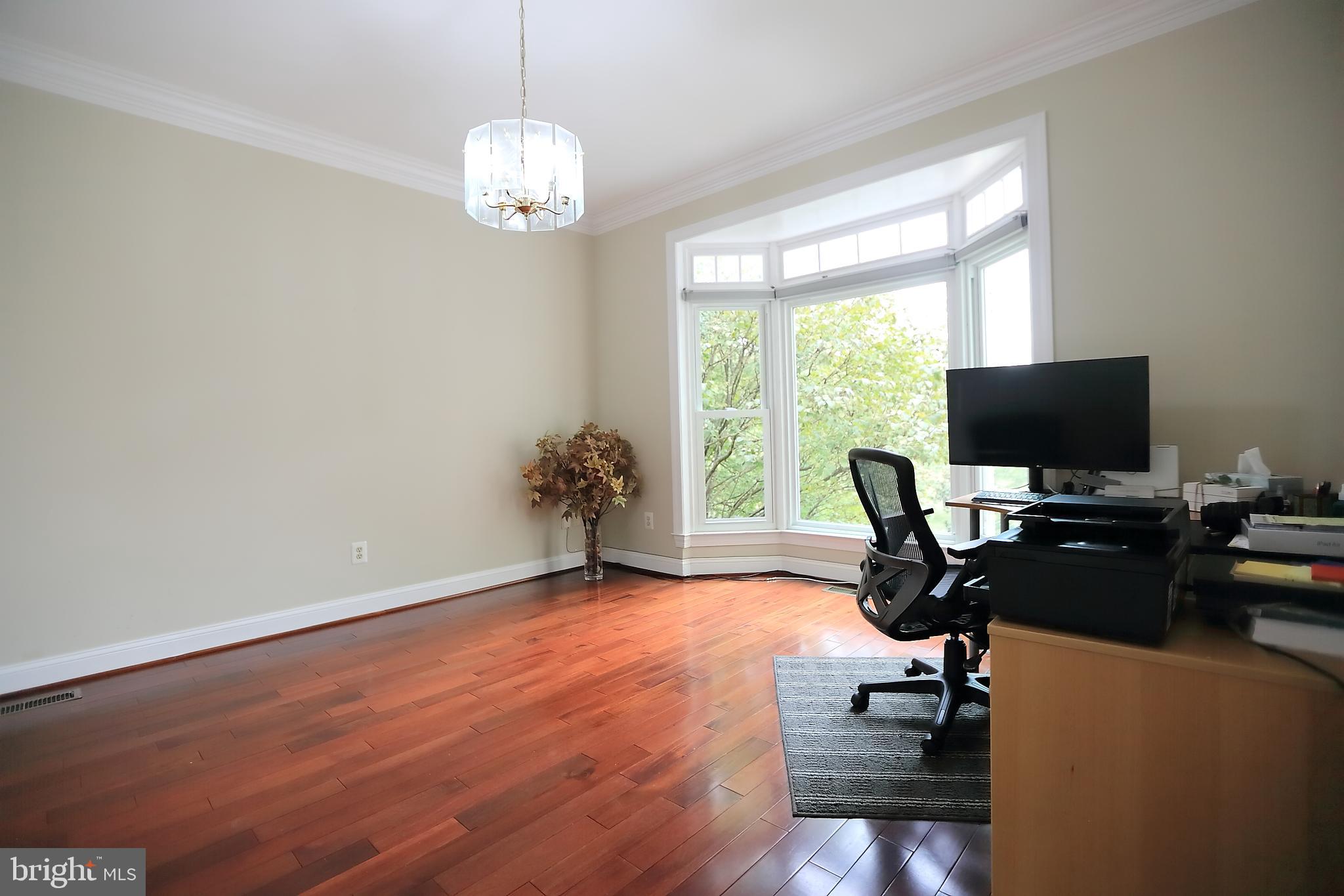 9731 Middleton Ridge Road Vienna, VA 22182 - Photo 32 of 39 a view of a workspace with furniture and a window
