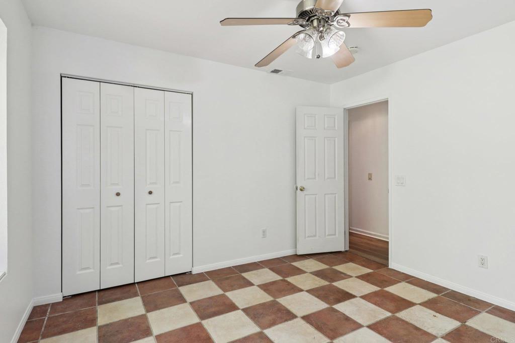 23833 Gymkhana Road Ramona, CA 92065 - Photo 13 of 29 a view of a livingroom with a chandelier fan and cabinets