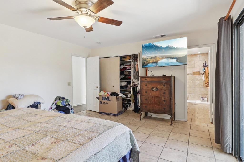 23833 Gymkhana Road Ramona, CA 92065 - Photo 16 of 29 a bedroom with a bed and cabinets