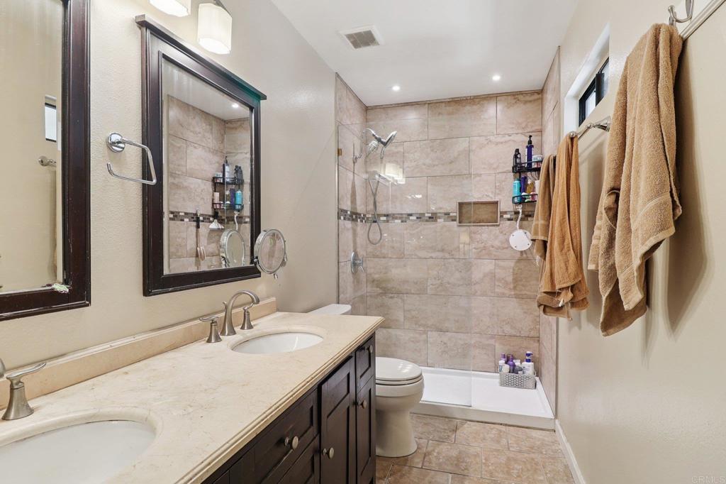 23833 Gymkhana Road Ramona, CA 92065 - Photo 17 of 29 a bathroom with a sink toilet double vanity and tub