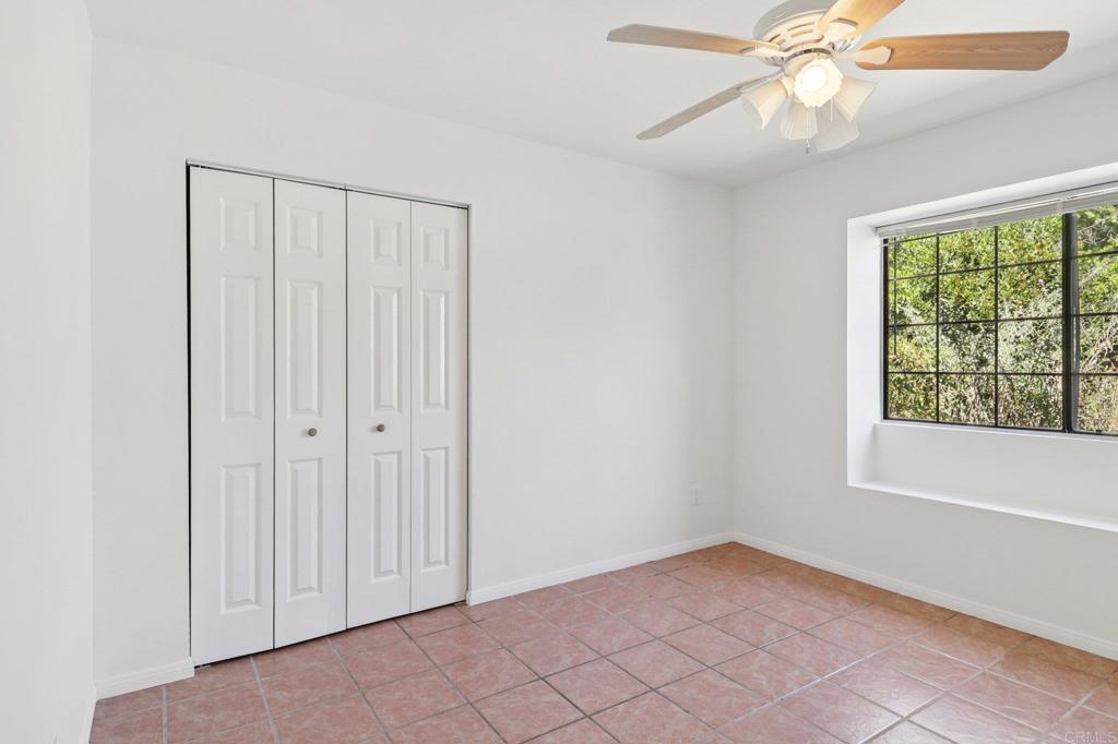 23833 Gymkhana Road Ramona, CA 92065 - Photo 20 of 29 an empty room with windows and fan