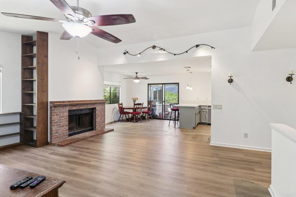 23833 Gymkhana Road Ramona, CA 92065 - Photo 3 of 29 a view of a livingroom with furniture a fireplace and wooden floor