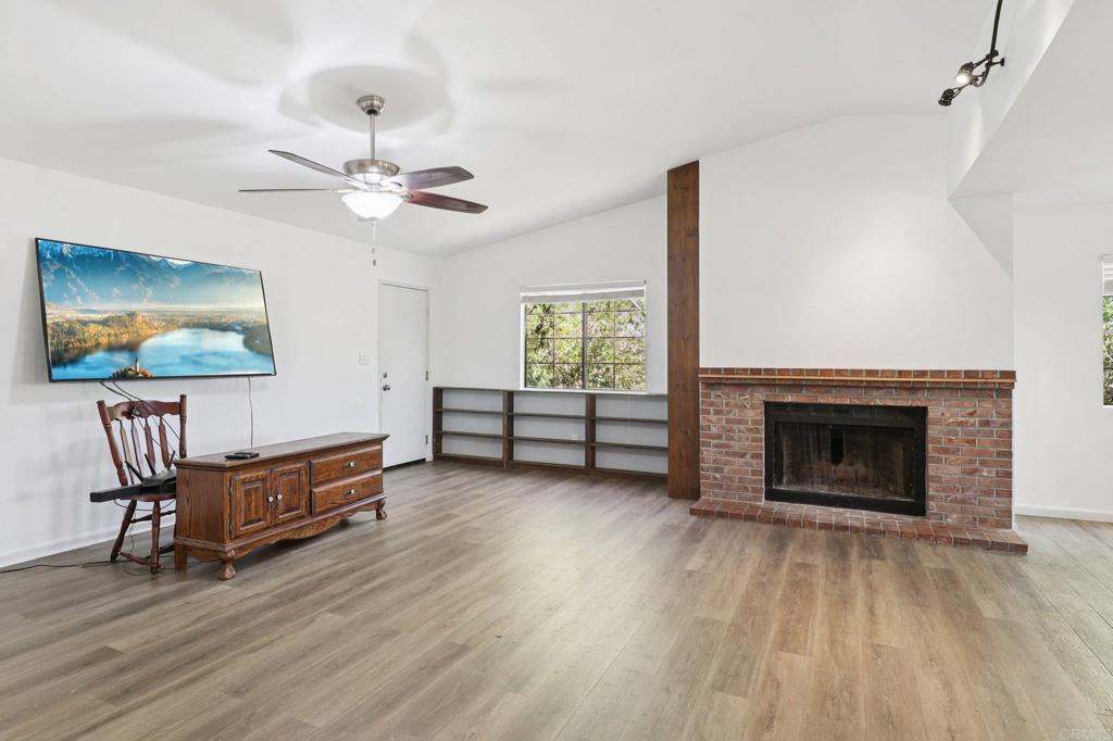 23833 Gymkhana Road Ramona, CA 92065 - Photo 5 of 29 a living room with furniture and a fireplace