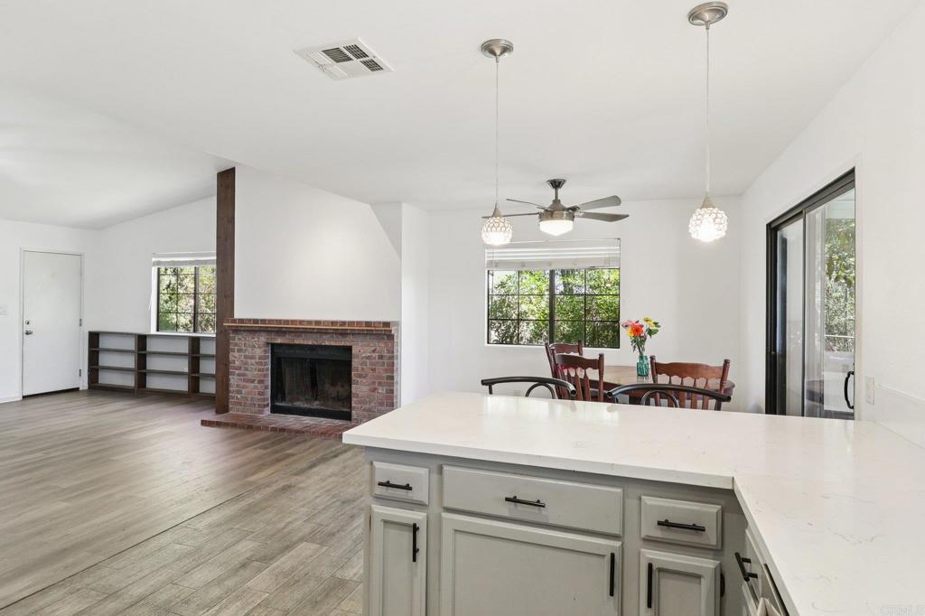 23833 Gymkhana Road Ramona, CA 92065 - Photo 8 of 29 a living room with furniture a fireplace and a chandelier