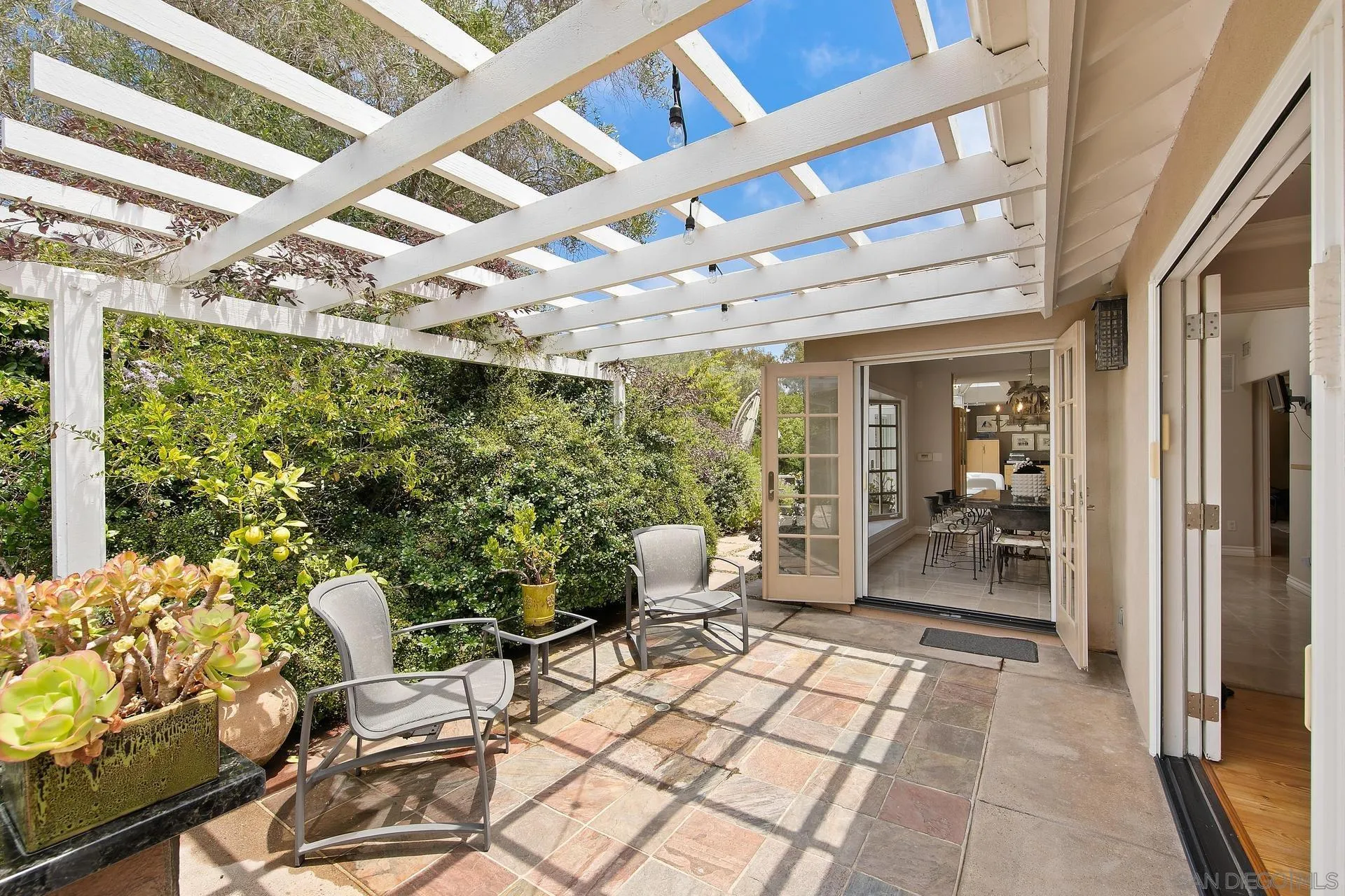 8491 Cliffridge Lane La Jolla, CA 92037 - Photo 21 of 38 a building outdoor space with patio furniture and potted plants