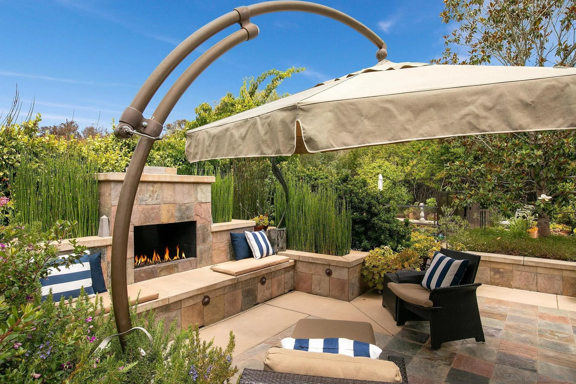 8491 Cliffridge Lane La Jolla, CA 92037 - Photo 22 of 38 a view of a patio with couches chairs under an umbrella