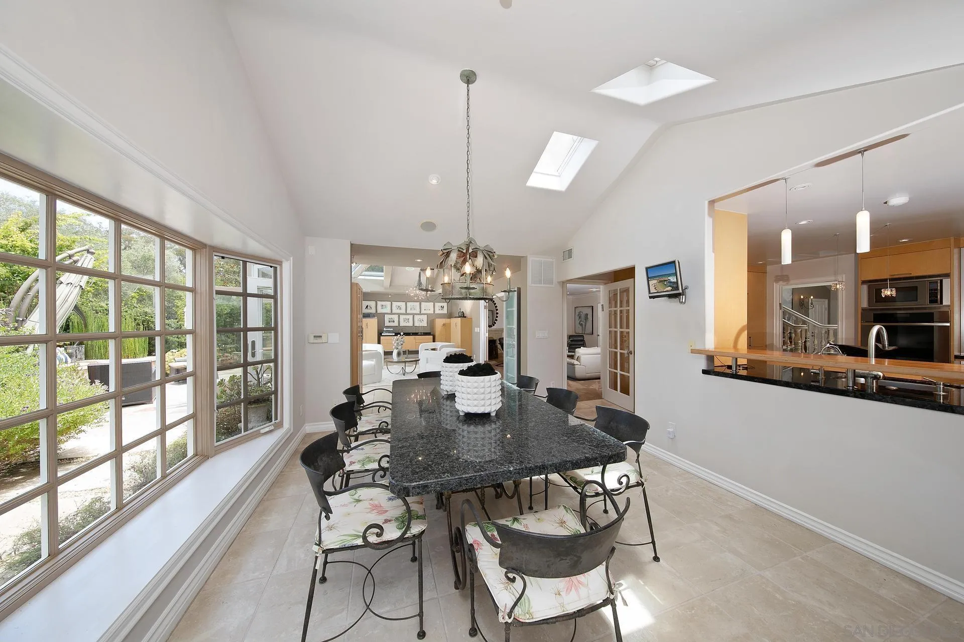 8491 Cliffridge Lane La Jolla, CA 92037 - Photo 23 of 38 a dining room with furniture a chandelier and wooden floor