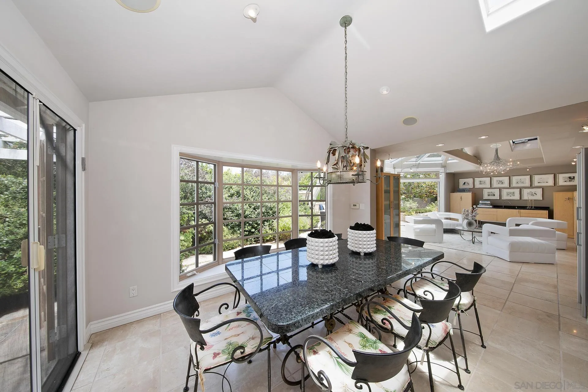 8491 Cliffridge Lane La Jolla, CA 92037 - Photo 24 of 38 a view of a dining room with furniture wooden floor and chandelier