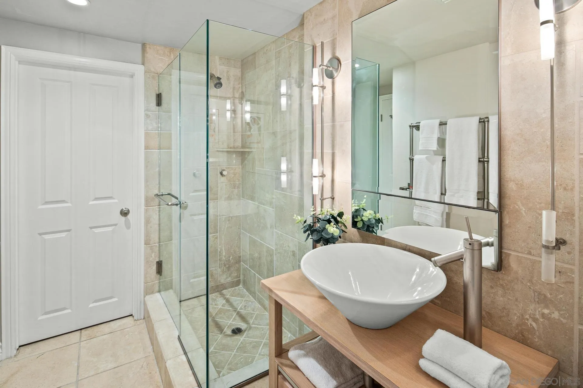8491 Cliffridge Lane La Jolla, CA 92037 - Photo 30 of 38 a bathroom with a tub shower sink and mirror