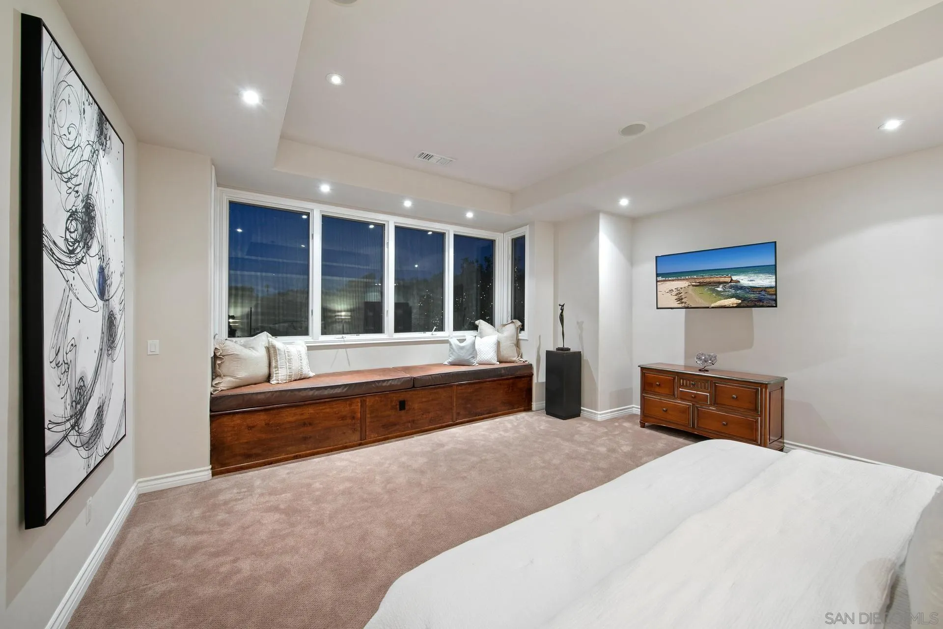 8491 Cliffridge Lane La Jolla, CA 92037 - Photo 33 of 38 a spacious bedroom with a large bed and a dresser