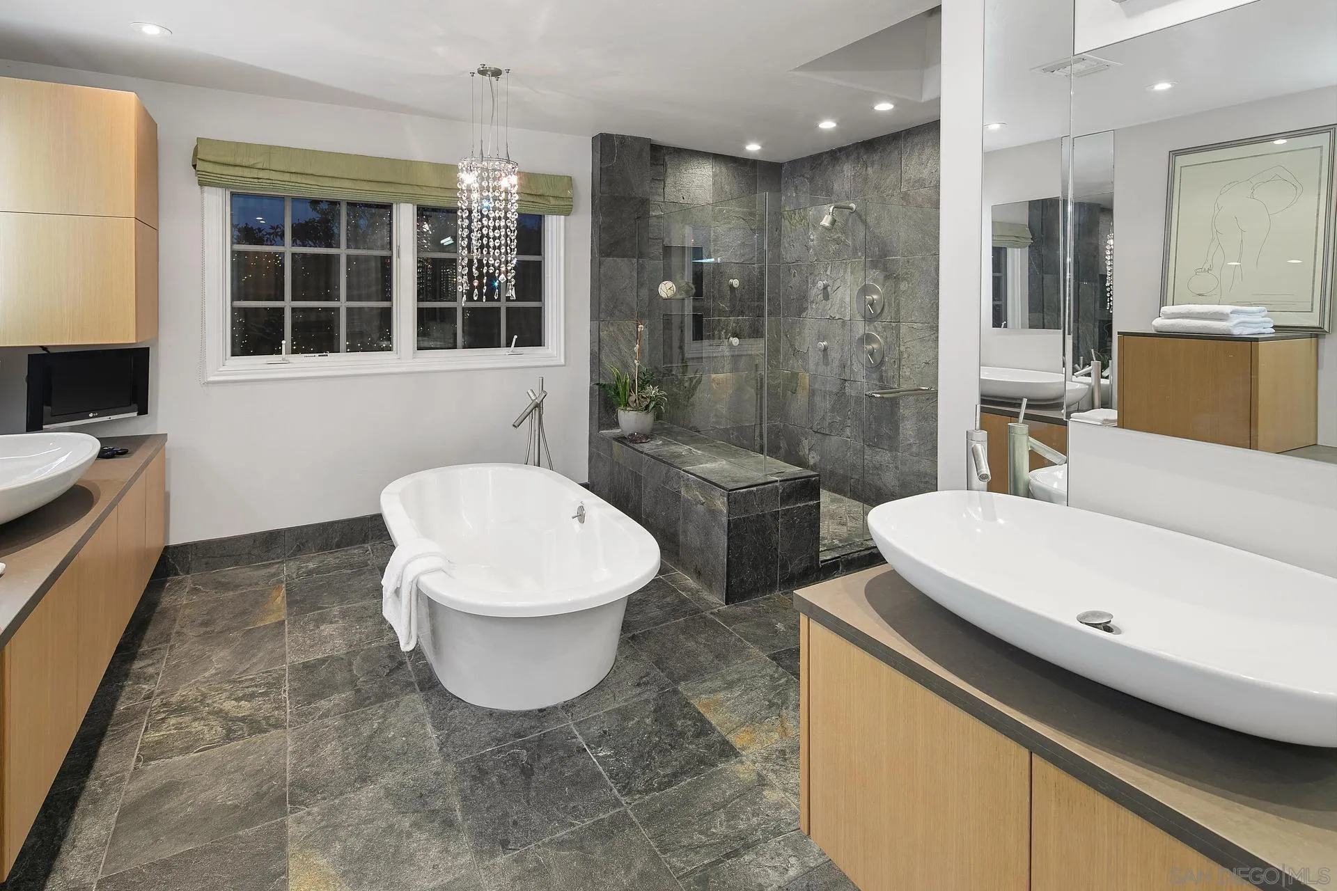 8491 Cliffridge Lane La Jolla, CA 92037 - Photo 34 of 38 a bathroom with a sink a toilet a mirror and shower