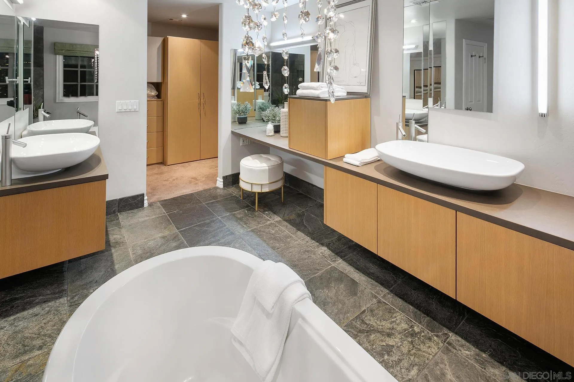 8491 Cliffridge Lane La Jolla, CA 92037 - Photo 36 of 38 a spacious bathroom with a granite countertop sink and a mirror