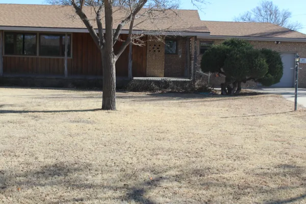 a view of house with backyard