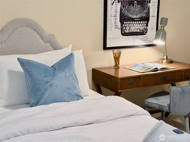 a bedroom with a bed and a chair