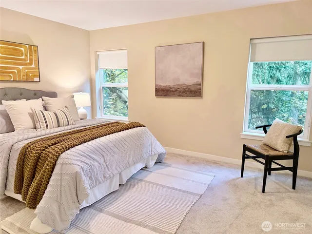 a bedroom with a bed and a chair