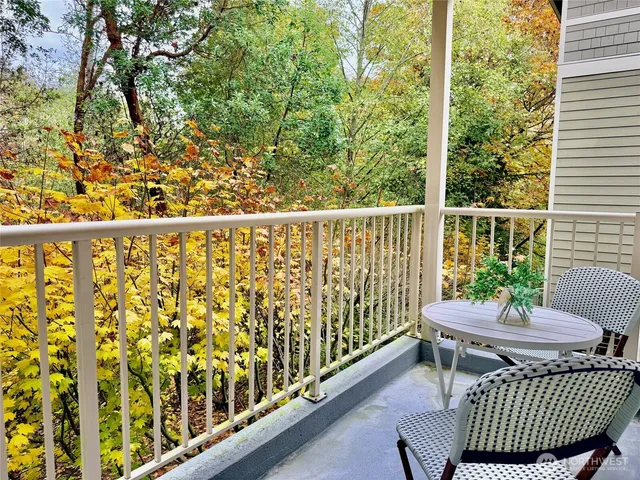 a bathroom with a granite countertop sink a toilet and a mirror
